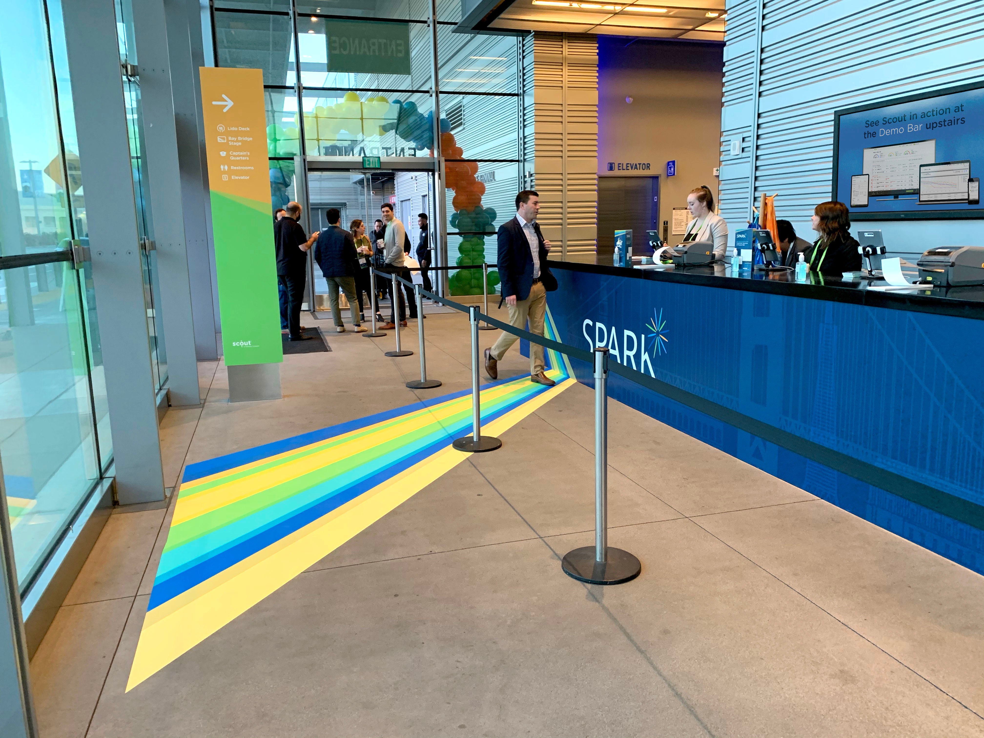 Registration desk with staff and guests for the Spark Customer Event