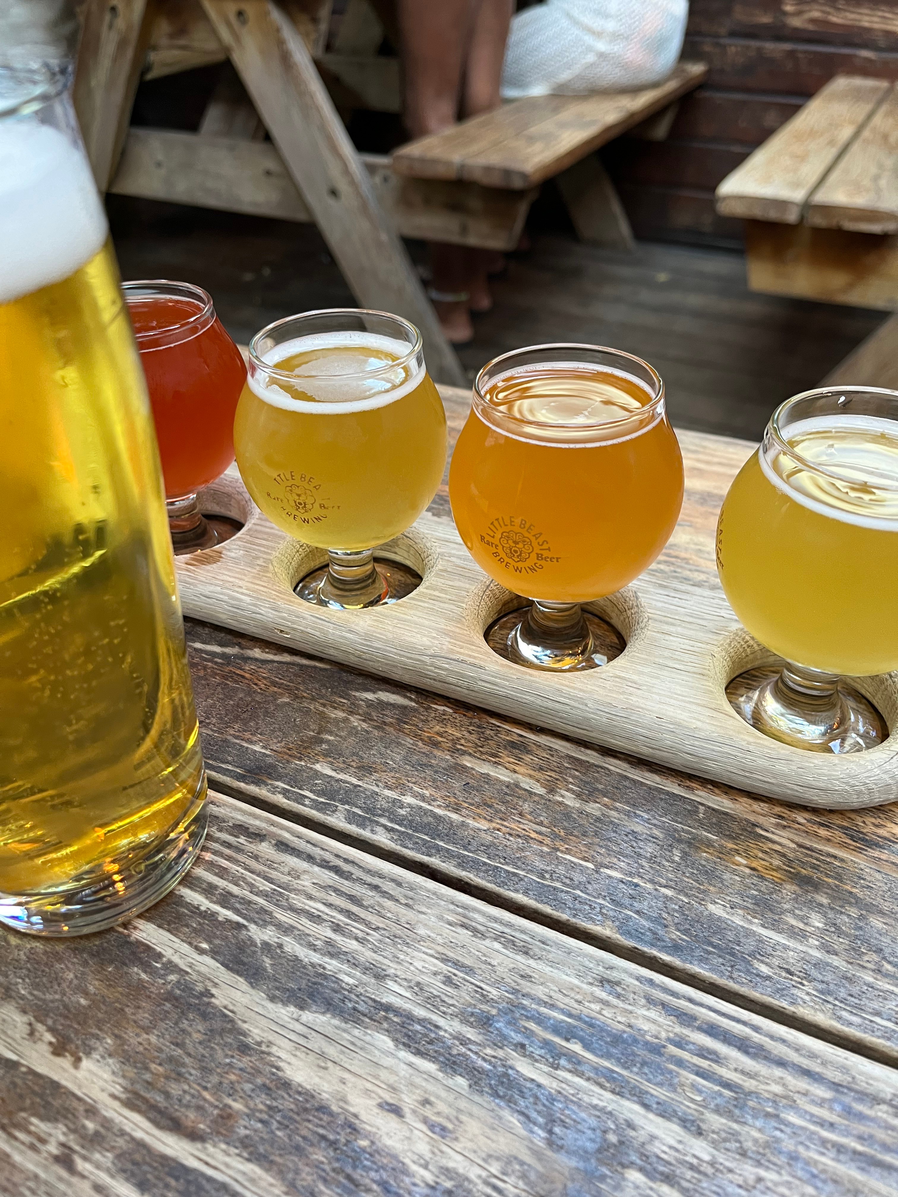 Beer in 4oz tasting set glasses, colors ranging from golden yellow to amber to burnt orange