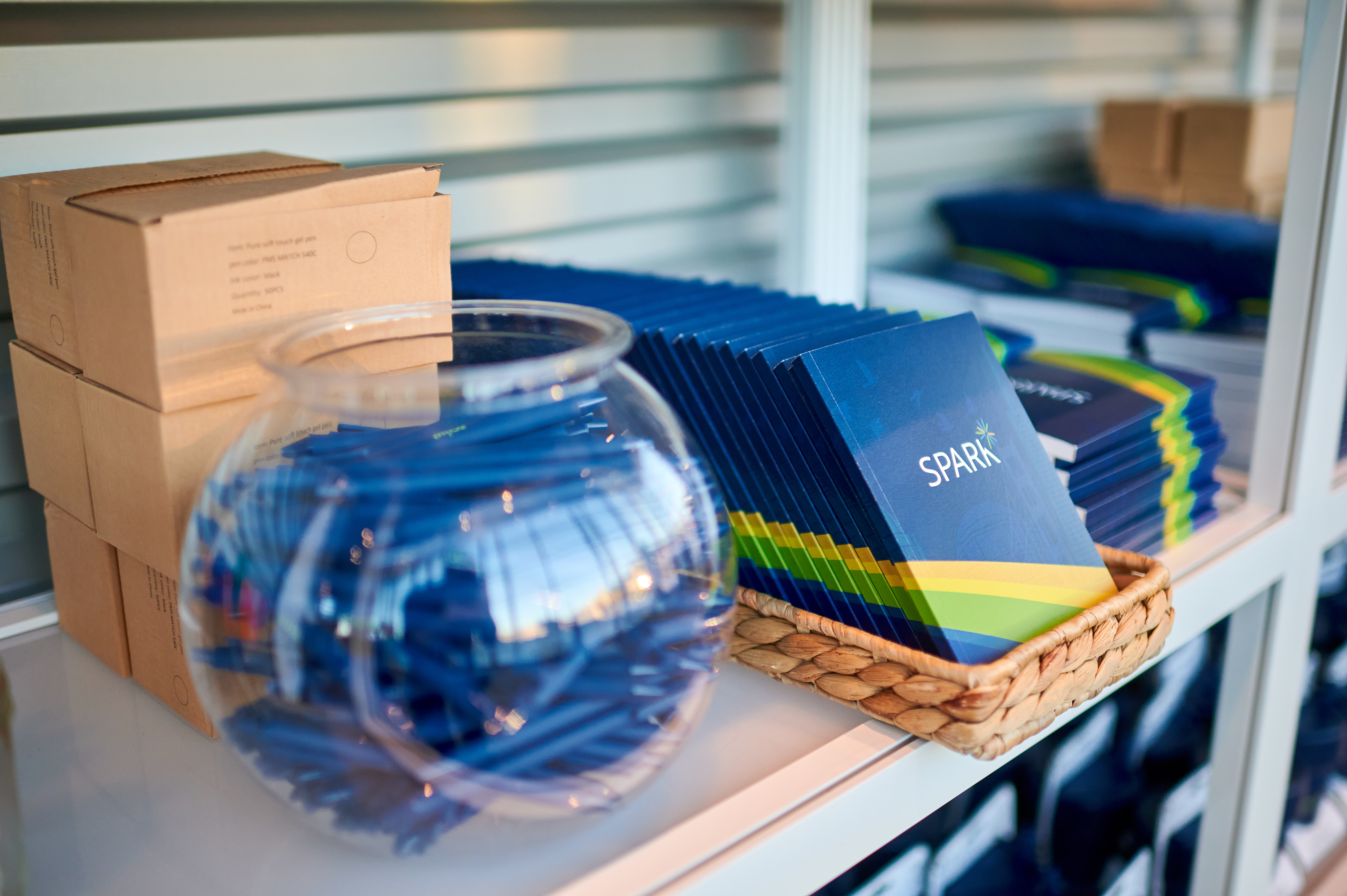 Branded pens and notebooks for guests at the Spark Customer Event