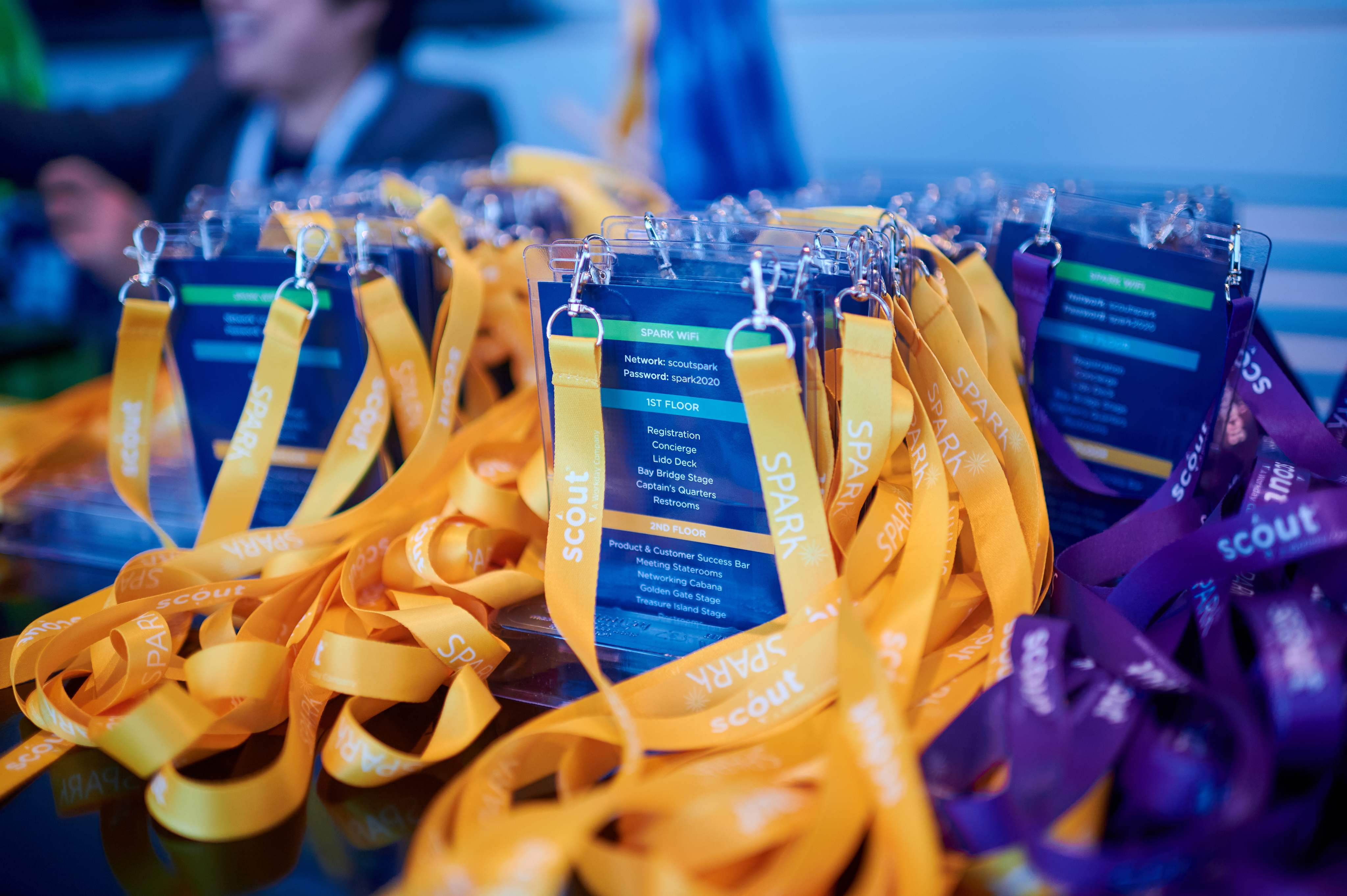 Name badges with colorful lanyards at the registration are of the Spark Customer Event