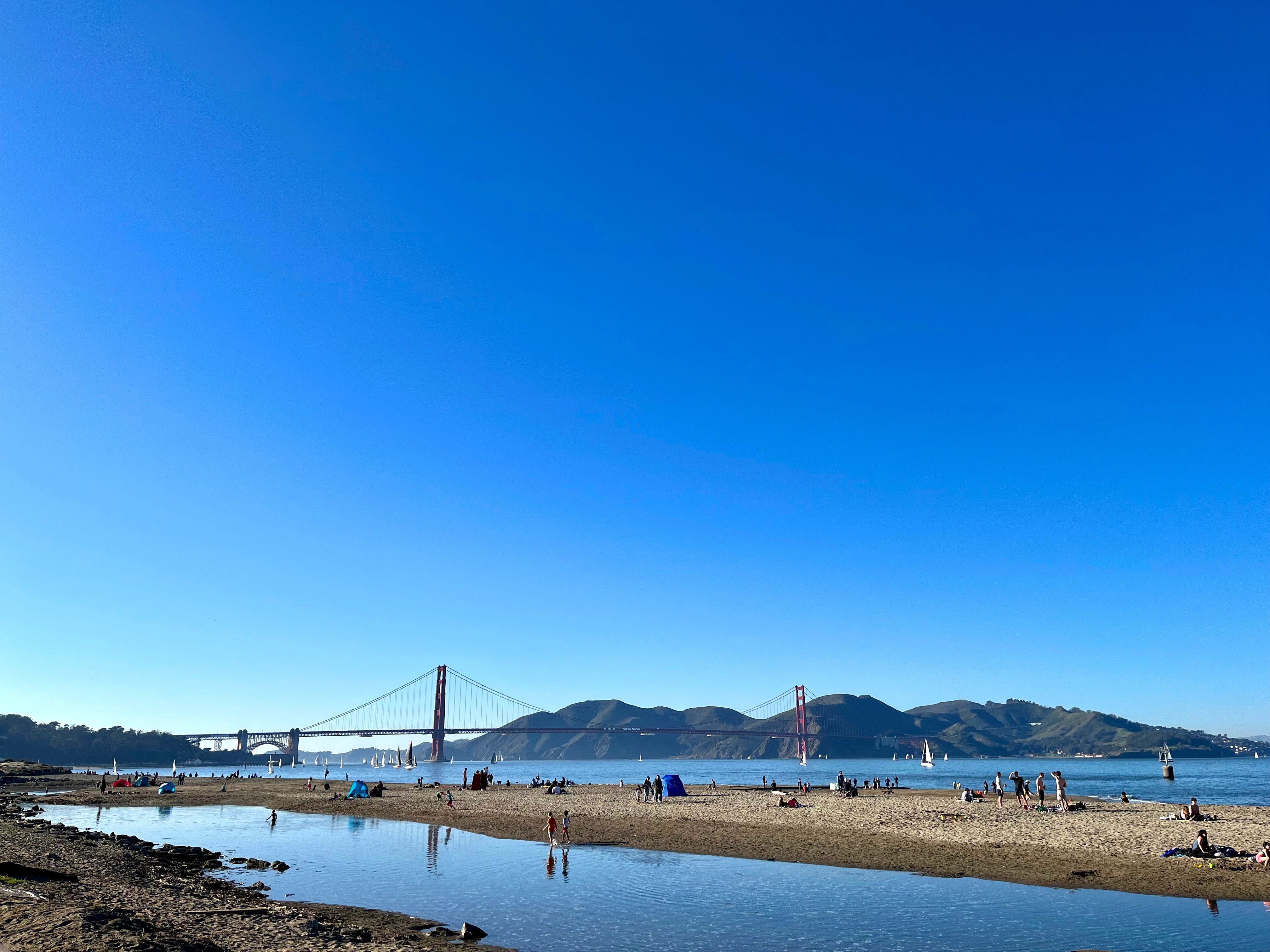 View of the Golden Gate Bridge from Crissy Field on a sunny, cloudless sky