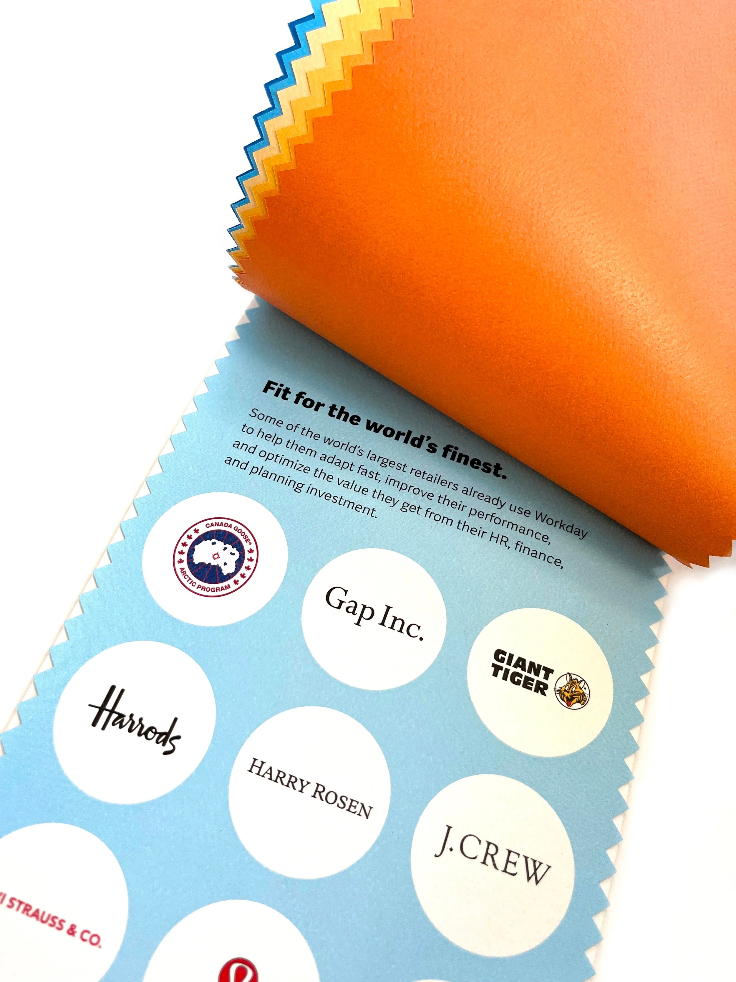 Close up of a printed piece with a page flipped upwards to show logos