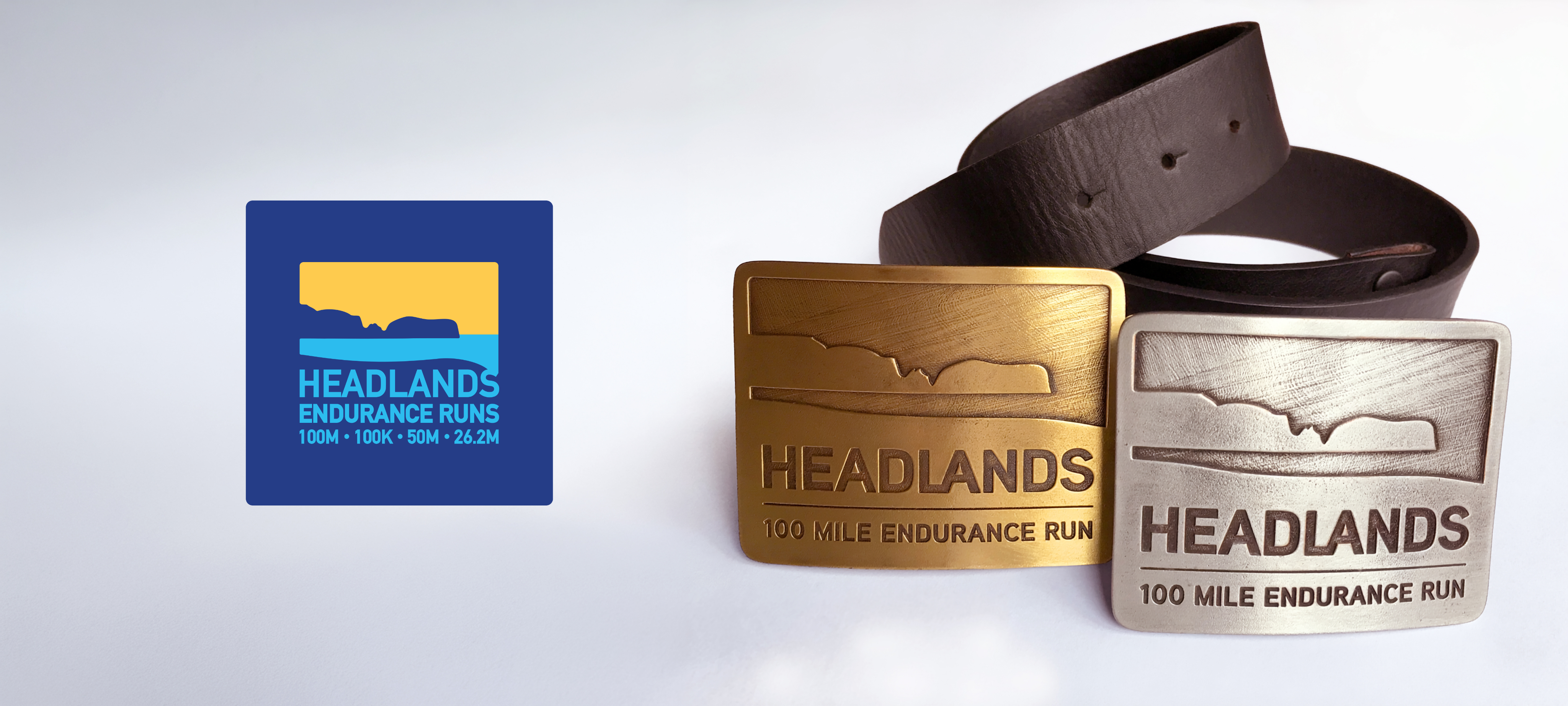 Logo for a running event next to two metal belt buckles featuring the logo as the design